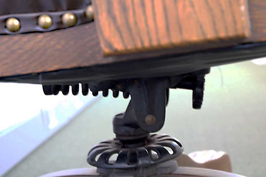 Photo detail of 573 ½ Swivel Chair, purchased by Cass Gilbert for the 1905 Minnesota State Capitol, carved wood with leather cushion on seat and back