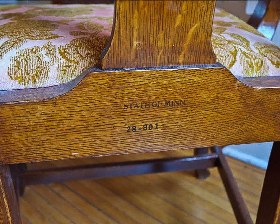 photo detail of 1087 Armchair, purchased by Cass Gilbert for the 1905 Minnesota State Capitol, carved wood with fabric cushion seat cover, located in Folsom House in Taylors Falls