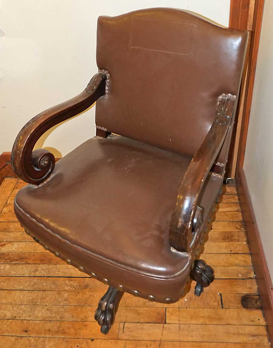 DD Swivel Chair at Clearwater County Historical Society  for the 1905 Minnesota State Capitol, carved wood, covered with leather